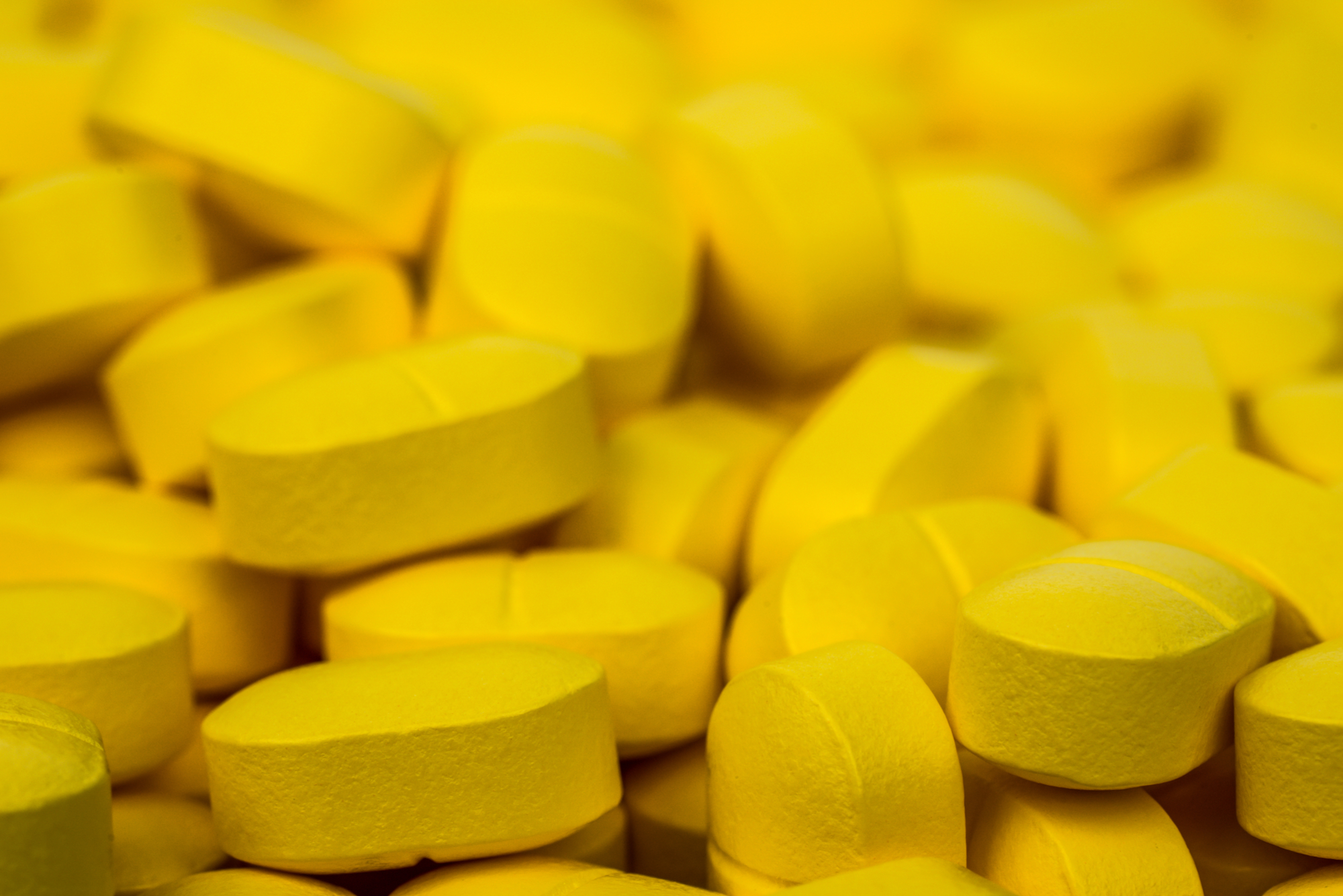 Close up on a pile of yellow pain pills