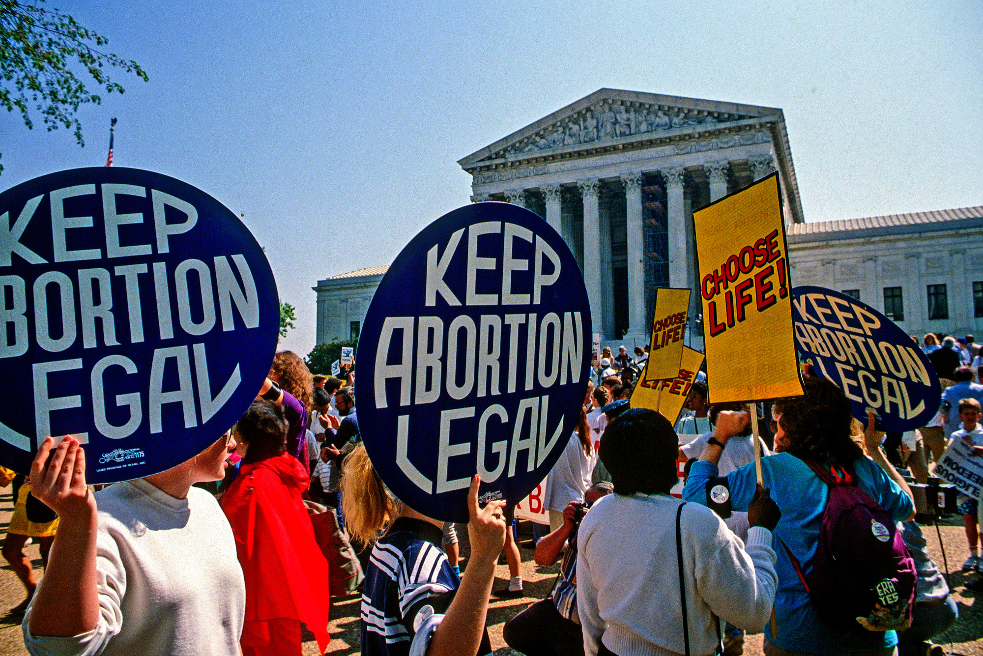 Pro-choice and pro-life protesters face off in front of the Supreme Court