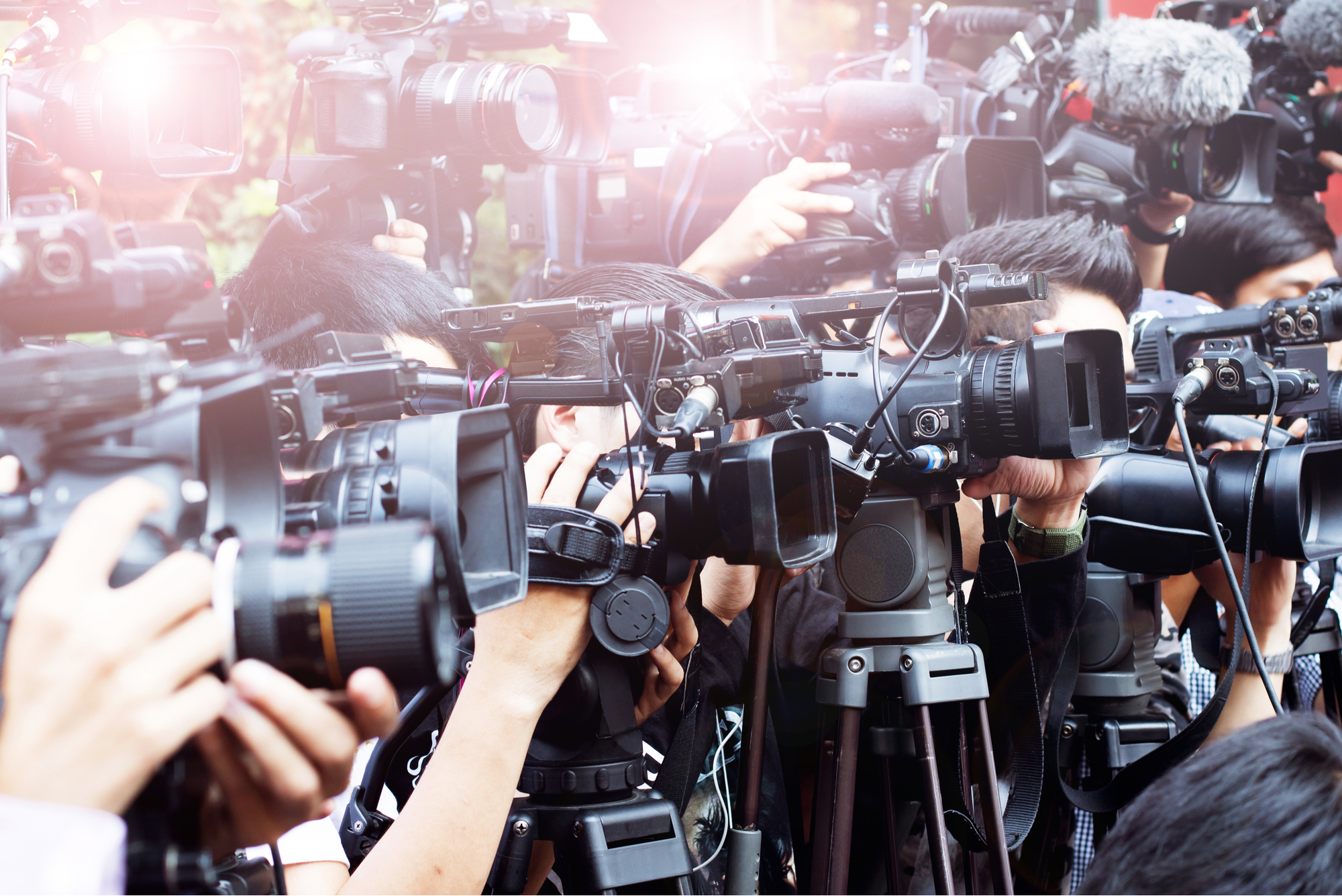 swarm of media and tv cameras