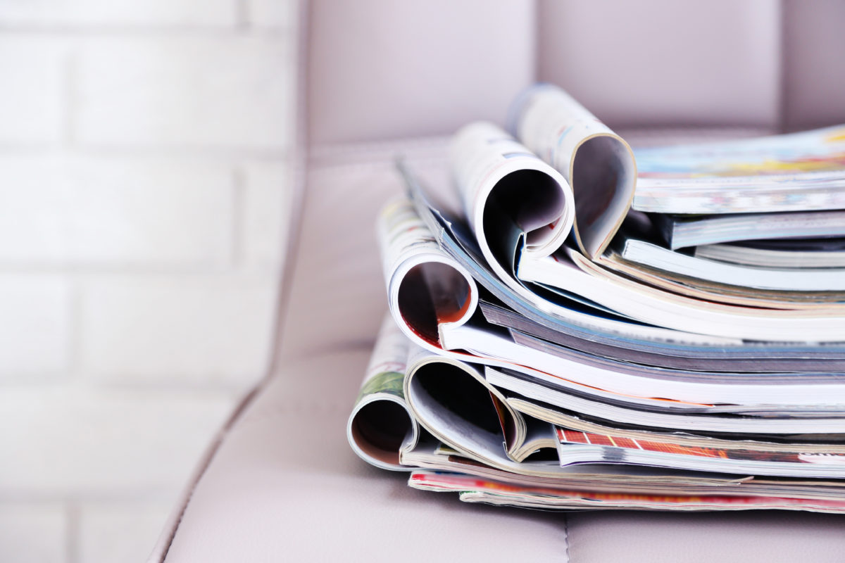 Photograph of a stack of magazines on a chair