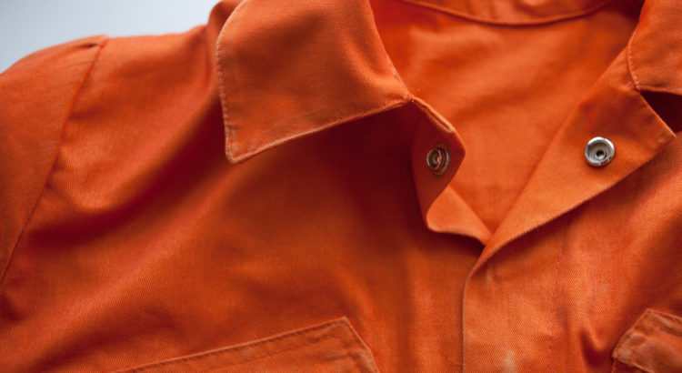 Up close shot of an orange prison jumpsuit