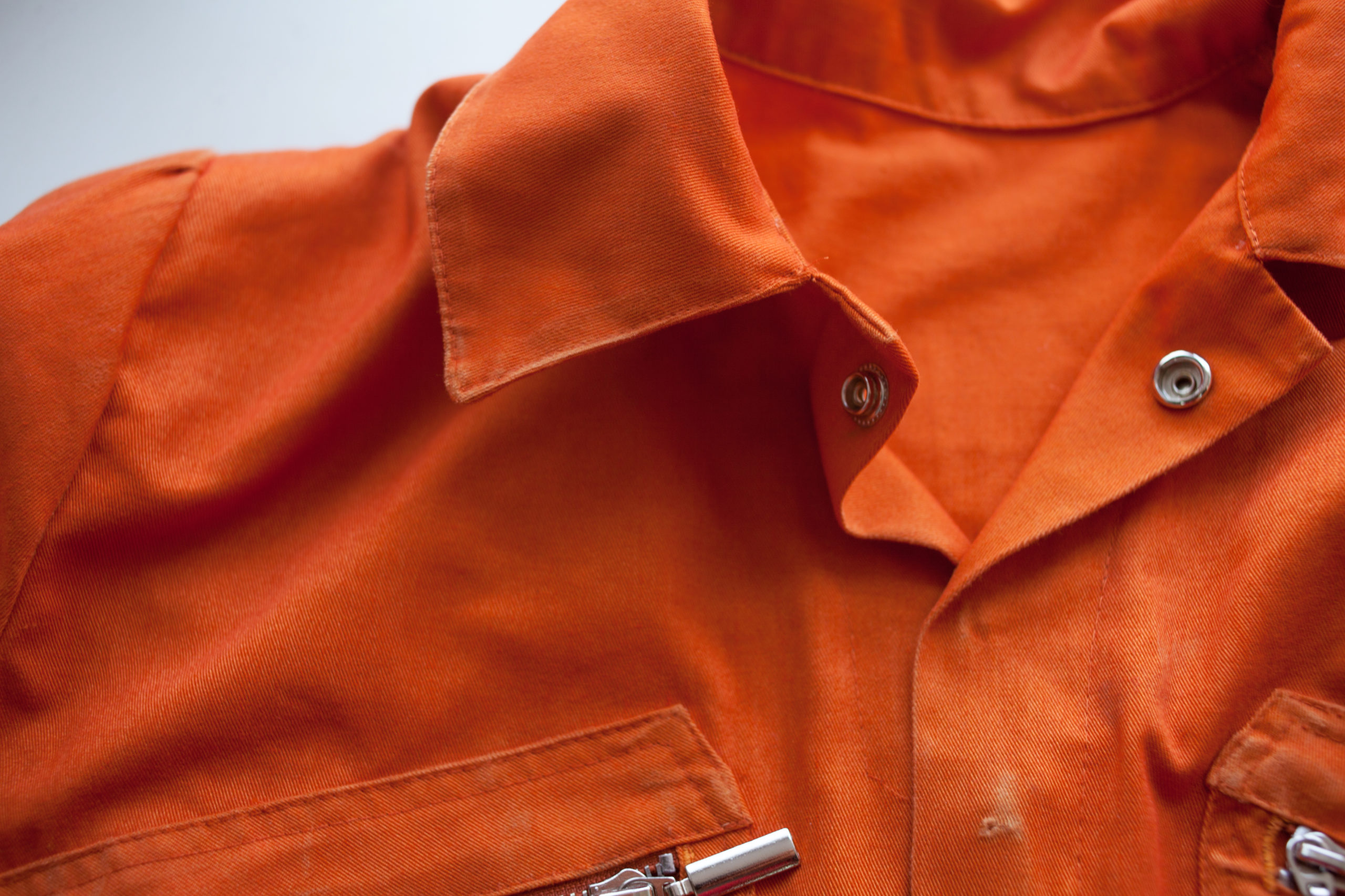 Up close shot of an orange prison jumpsuit