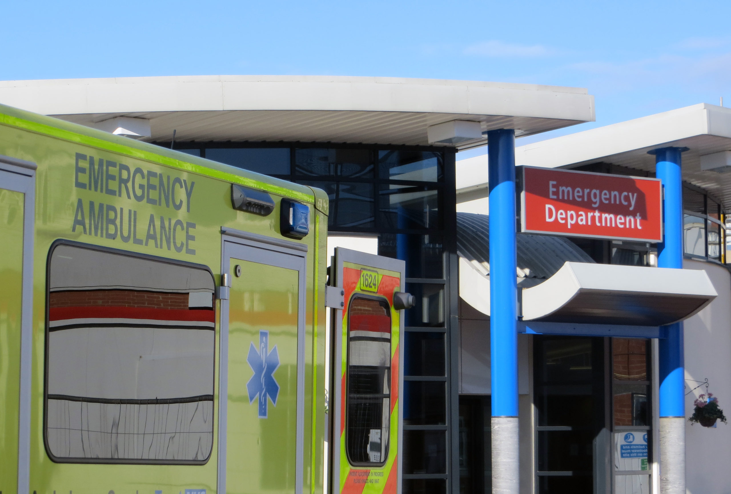 an ambulance parked at the entrance of an emergency department