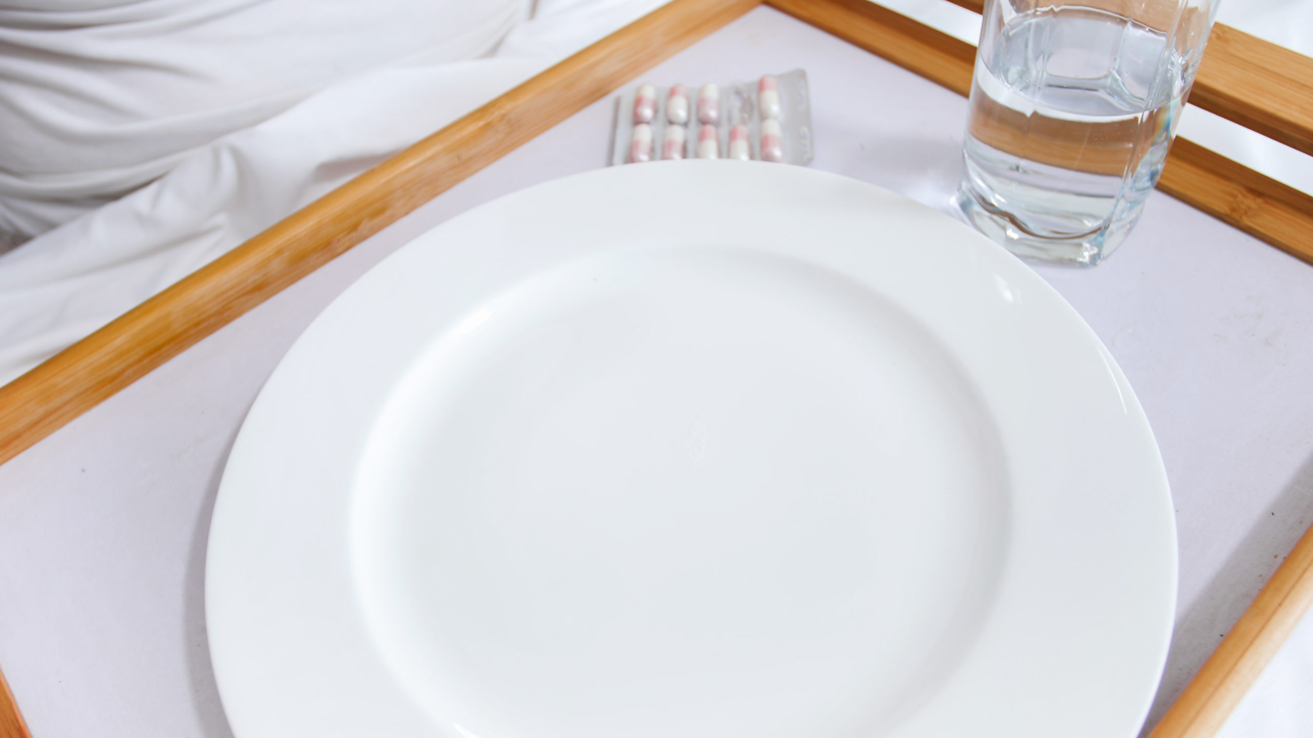 Empty hospital food tray with plate and glass