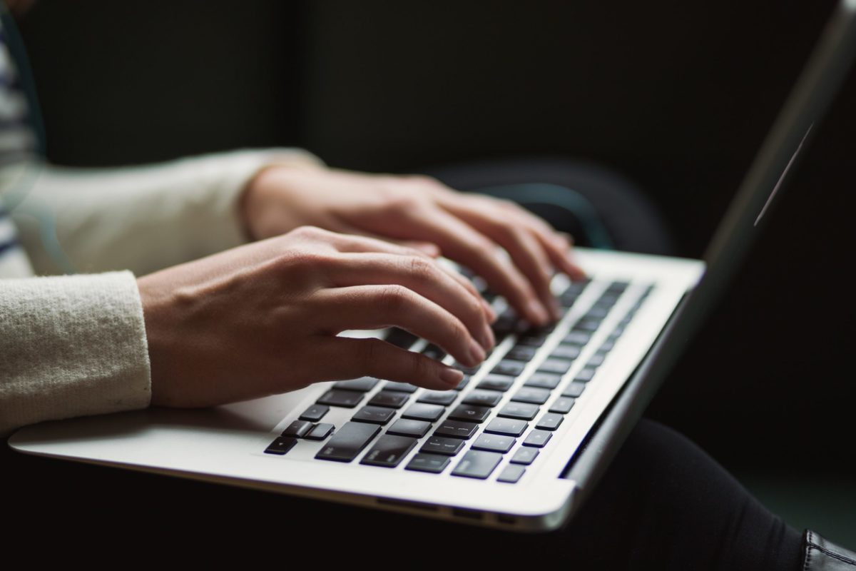 person typing at computer