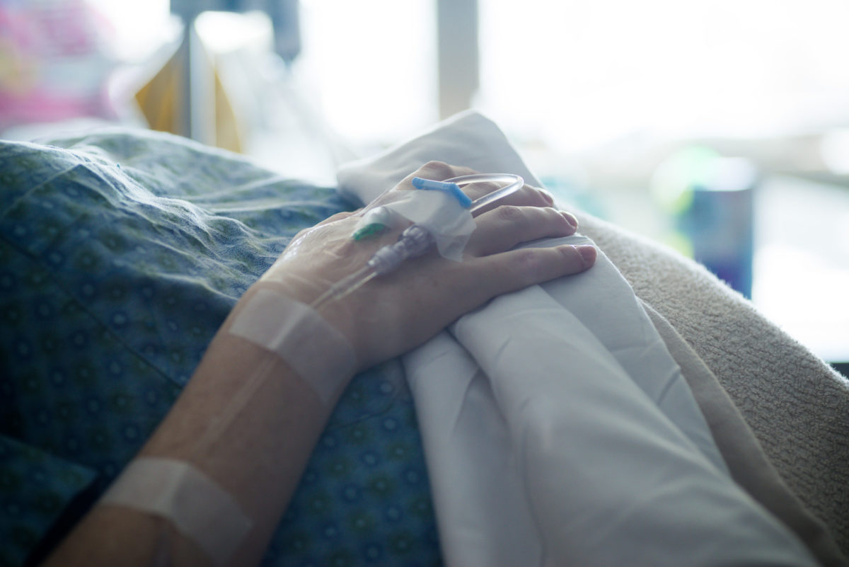 woman with iv in her hand in hospital. Labor and delivery preparation. Intravenious therapy infusion. shallow depth of field. selective focus