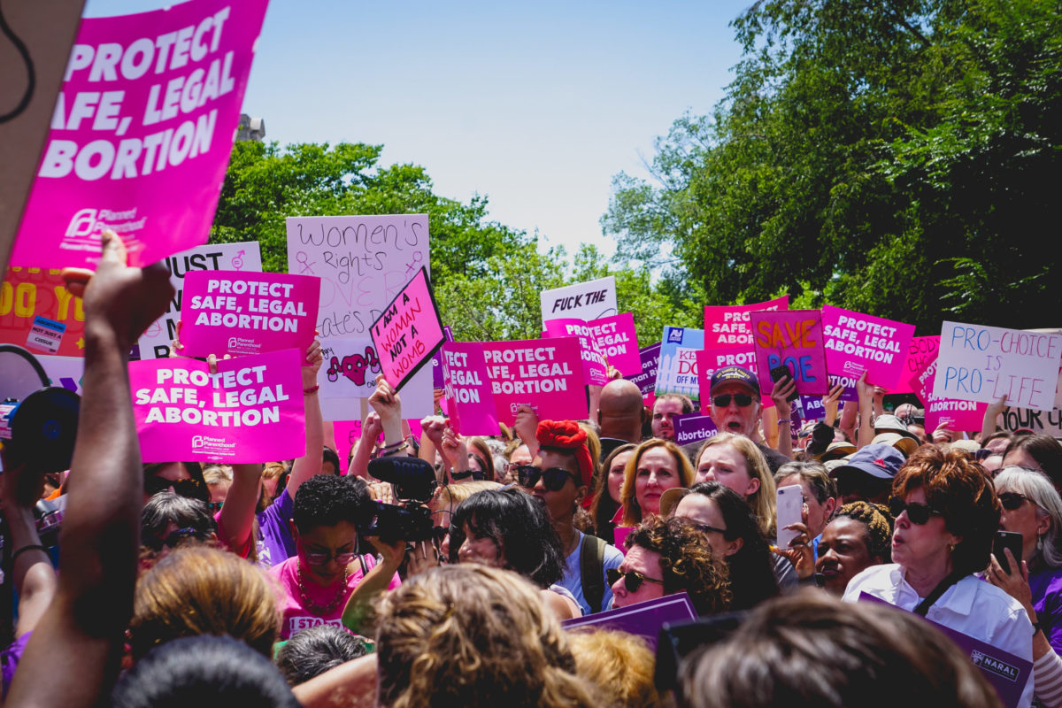 WASHINGTON, DC - MAY 21, 2019: A crowd of women hold signs supporting reproductive justice at the #StopTheBans rally in DC.