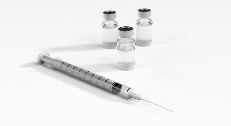 Syringe and vials of vaccine.