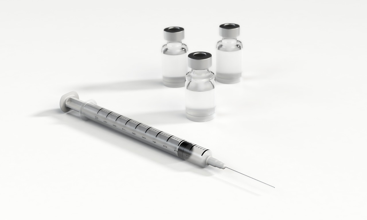 Syringe and vials of vaccine.