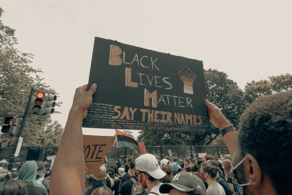 Man holds up a sign at the Black Lives Matter protest in Washington DC 6/6/2020.