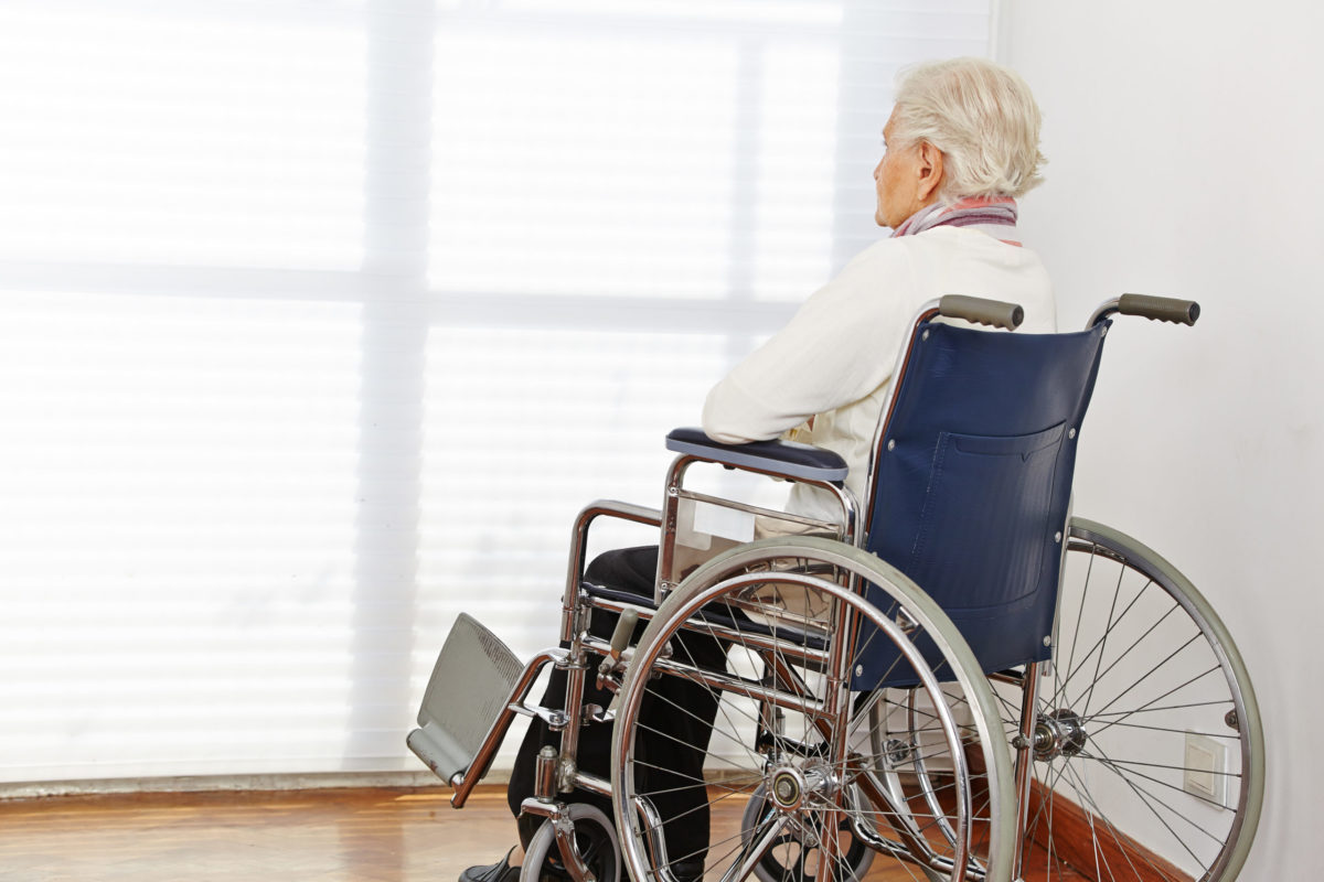 Senior citizen woman in wheelchair in a nursing home.