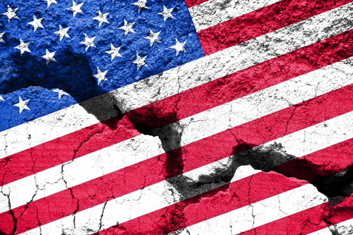 America divided concept, american flag on cracked background.