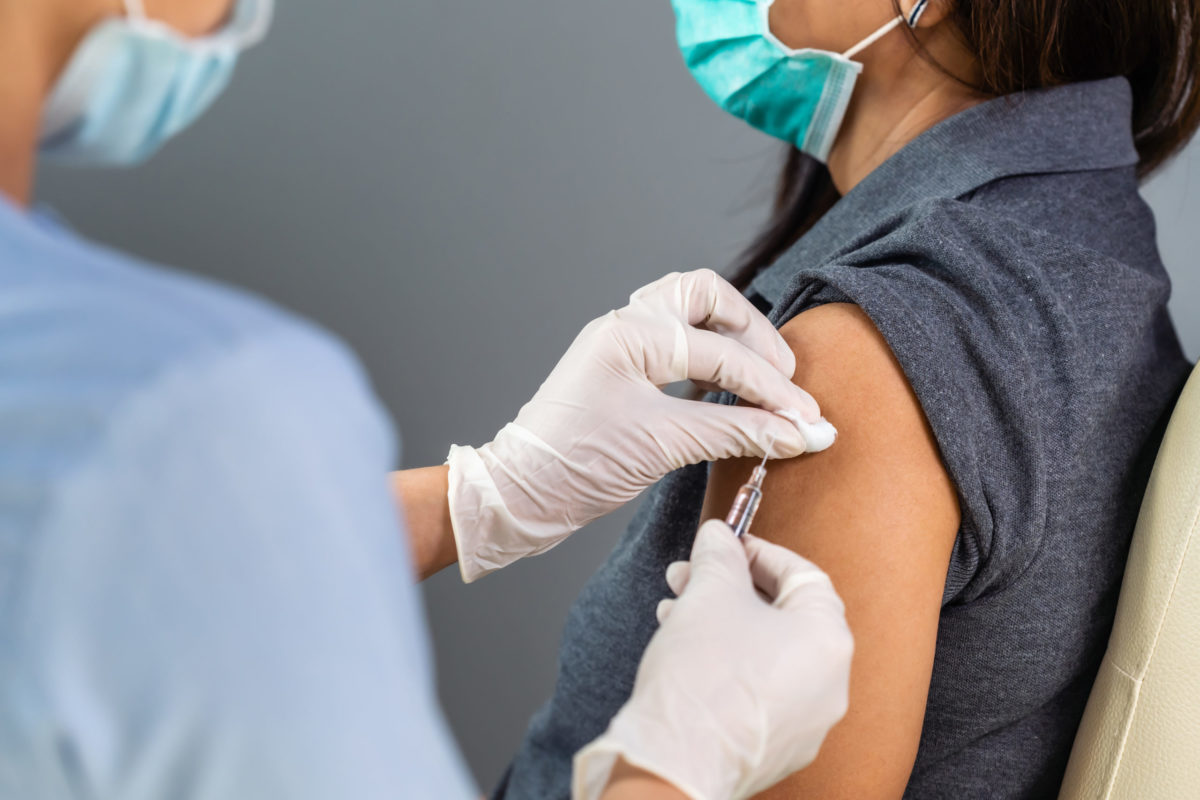 Person receiving vaccine.