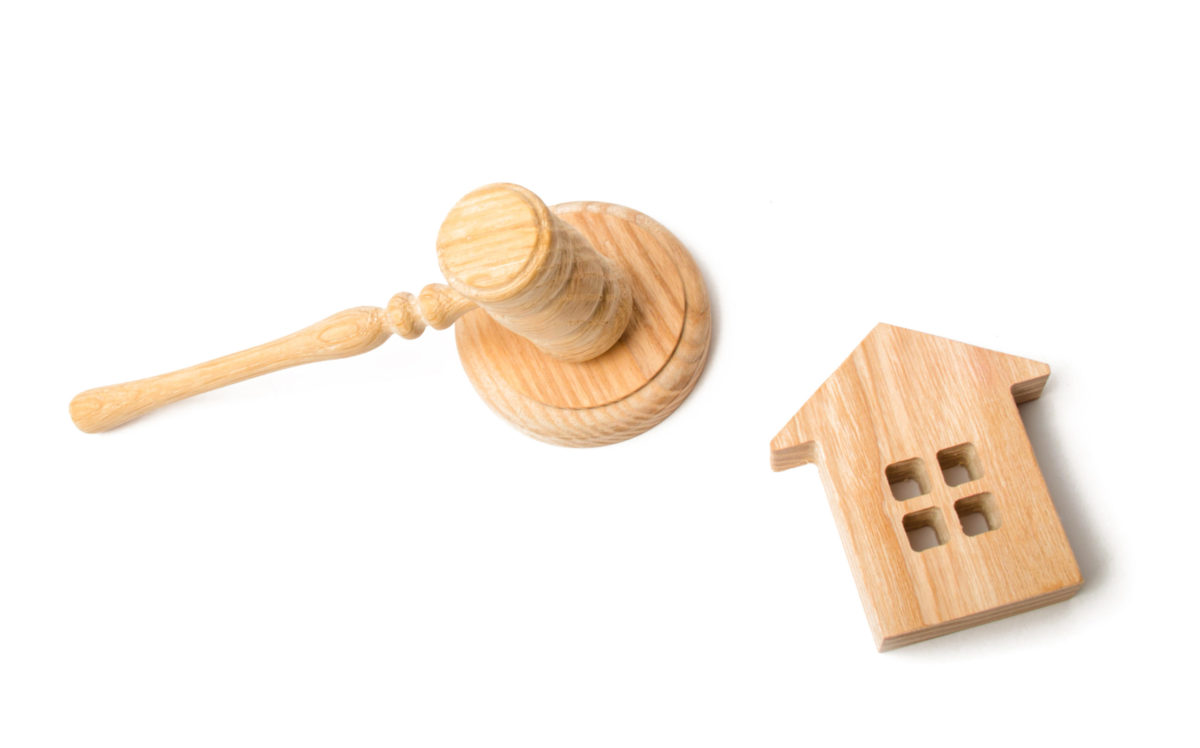 Gavel and a house on a white background. Concept art for eviction.