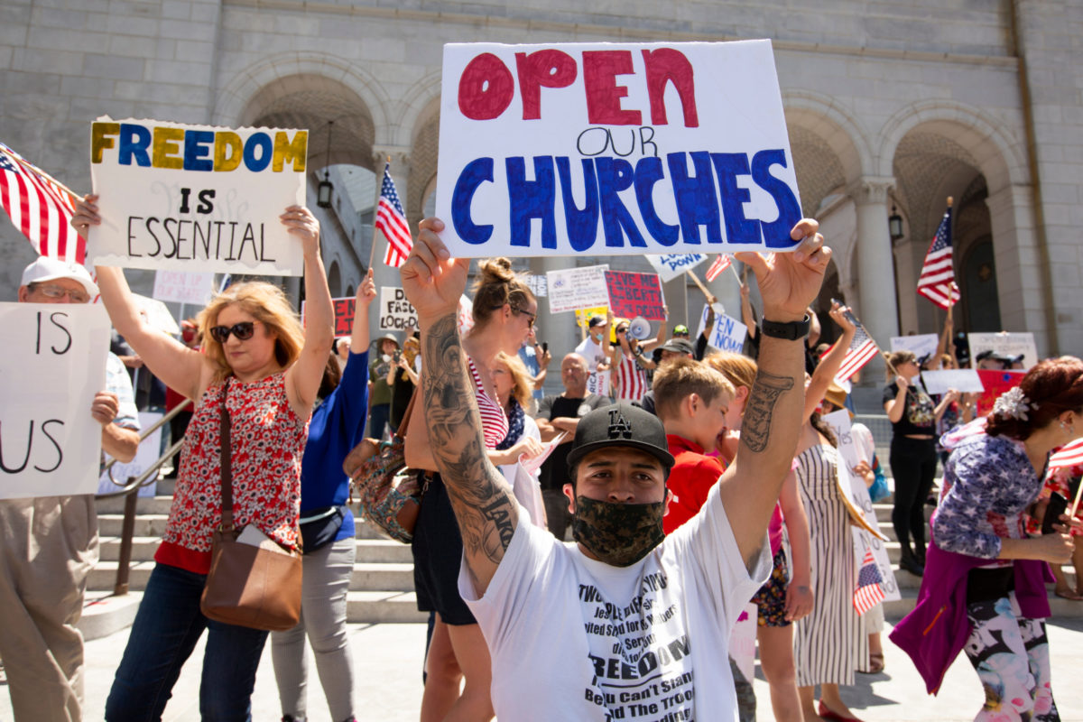 Los Angeles, California / USA - May 1, 2020: People in front of Los Angeles’ City Hall protest the state’s COVID-19 stay at home orders in a “Fully Open California” protest.