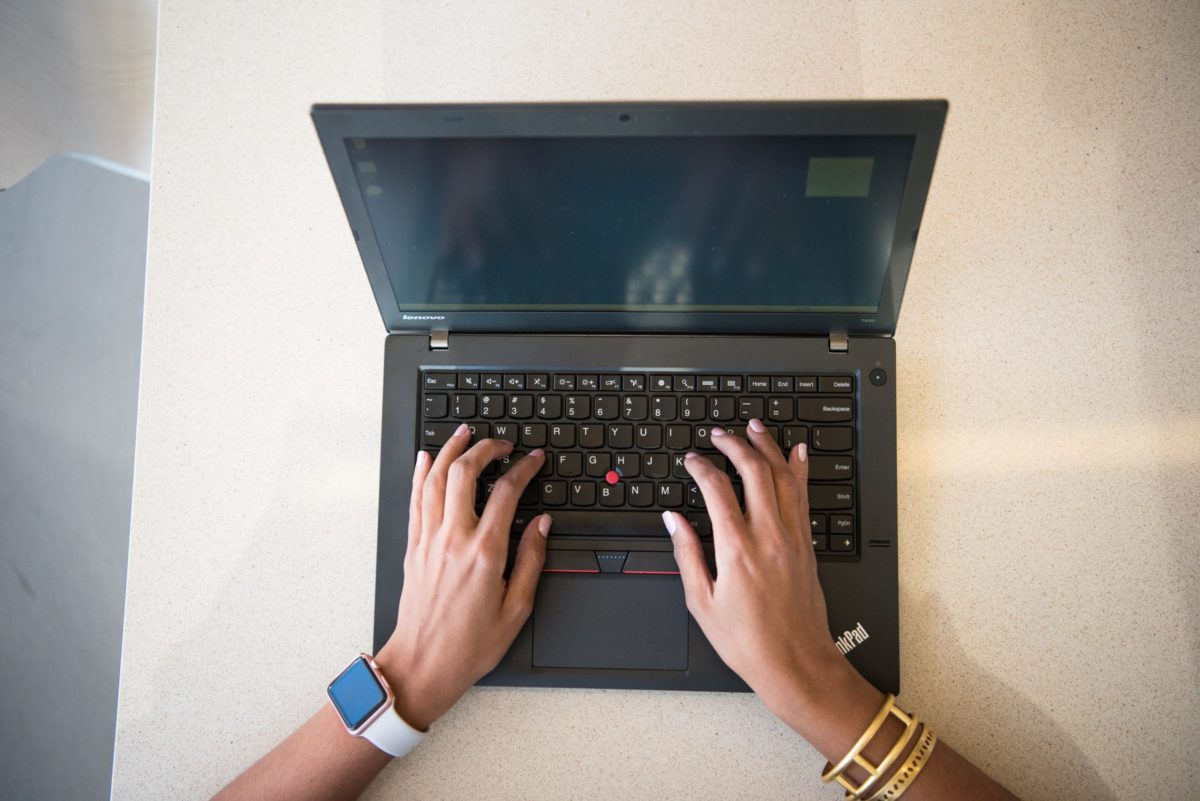 hands on keyboard of laptop computer.