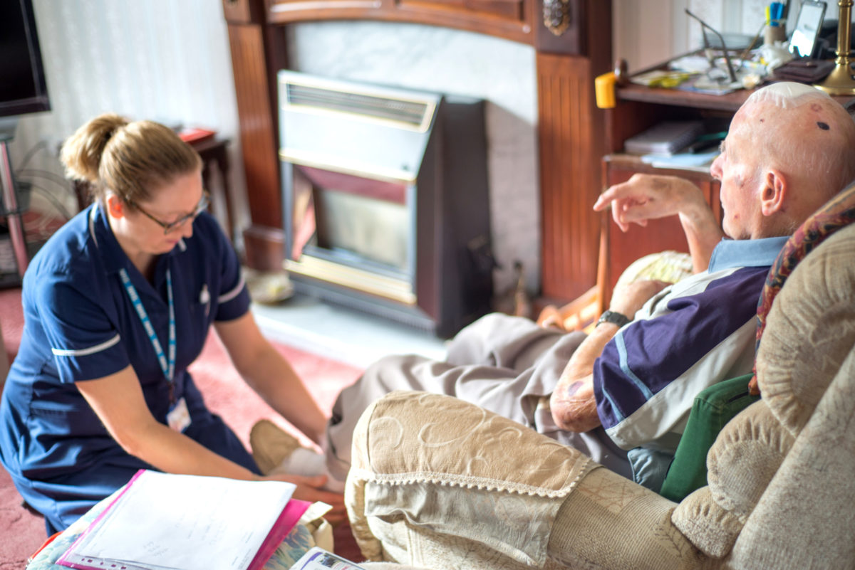 ANDOVER,HAMPSHIRE/UNITED KINGDOM-NOVEMBER 6 2019:A district nurse visits a ninety-four year old patient at his home to treat for pulmonary edema and head/brain injury.