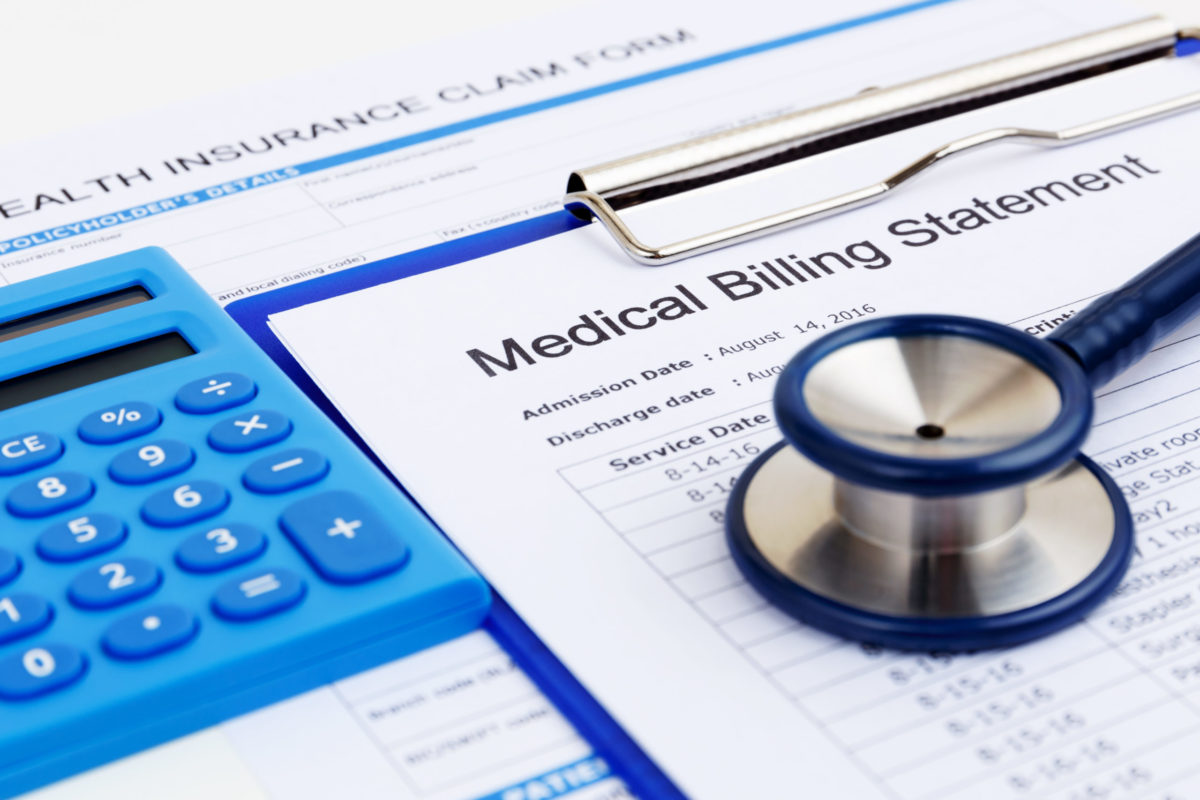 Medical bill and health insurance claim form with calculator.