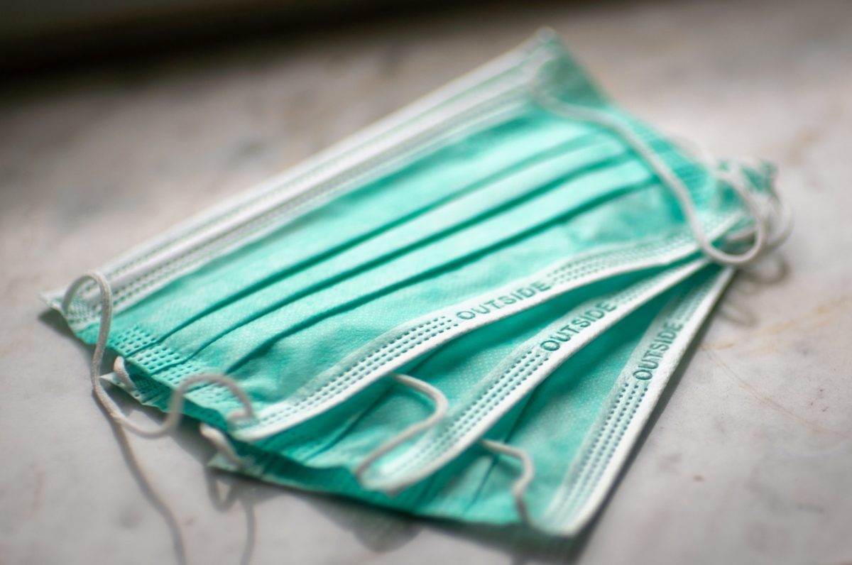 A pile of three surgical masks.