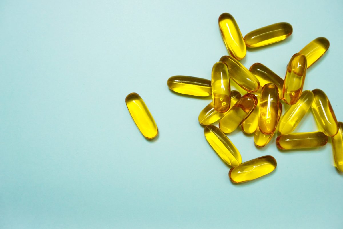 yellow capsules on a blue background.