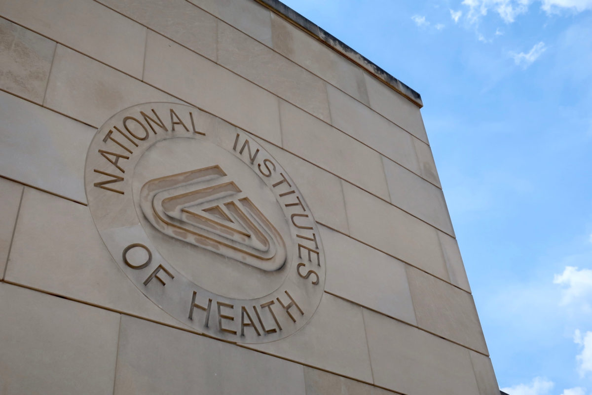 BETHESDA, MD - JUNE 29, 2019: NIH NATIONAL INSTITUTES OF HEALTH sign emblem seal on gateway center entrance building at NIH campus. The NIH is the US's medical research agency.