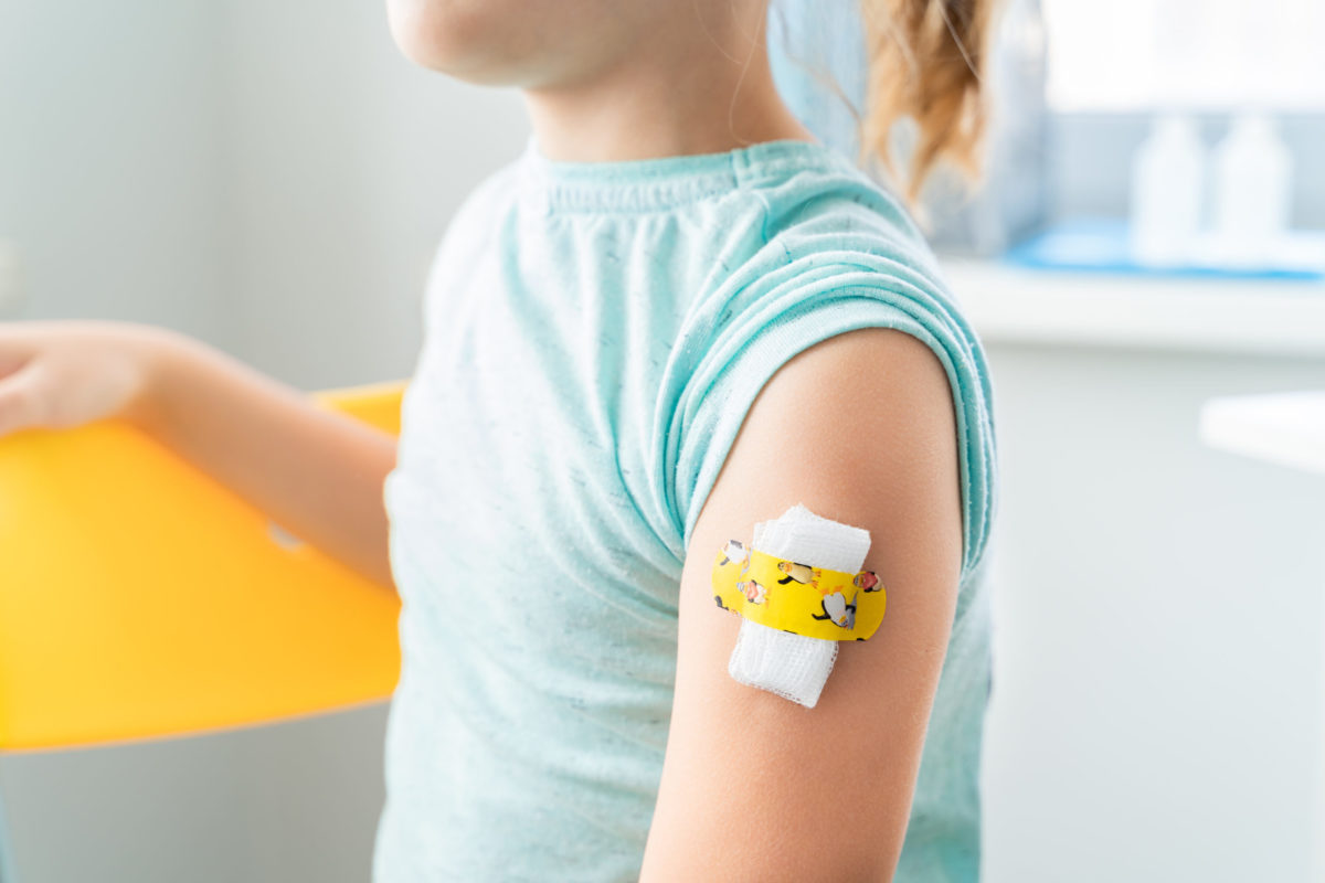 Child with bandaid on arm.