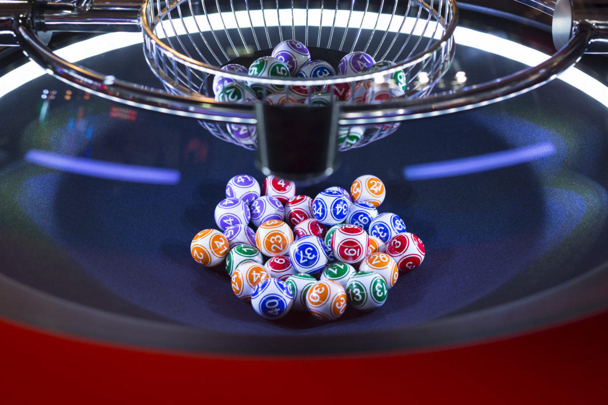 Colorful lottery balls in a rotating bingo machine.