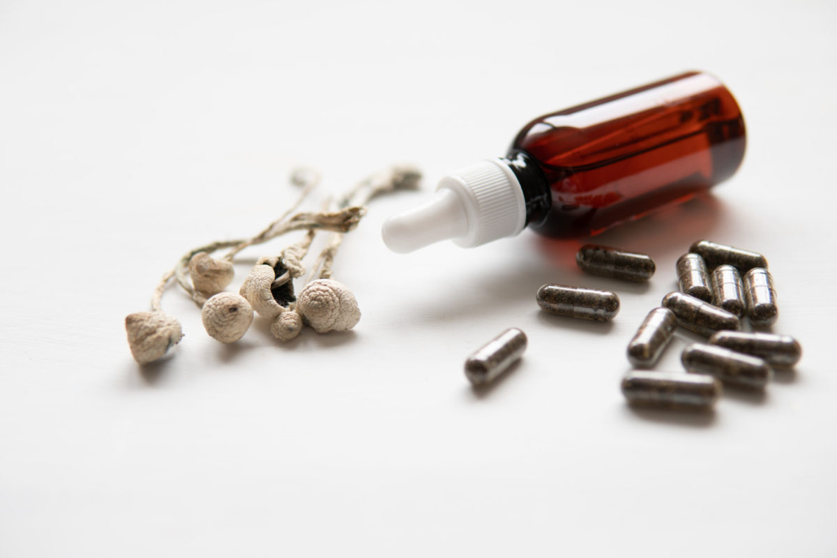 Mushrooms, capsules, and dropper bottle.