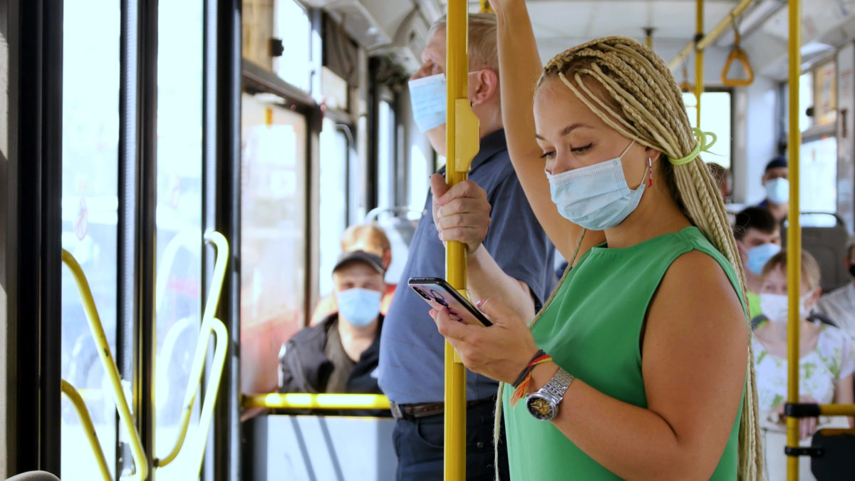 People wearing masks on bus.