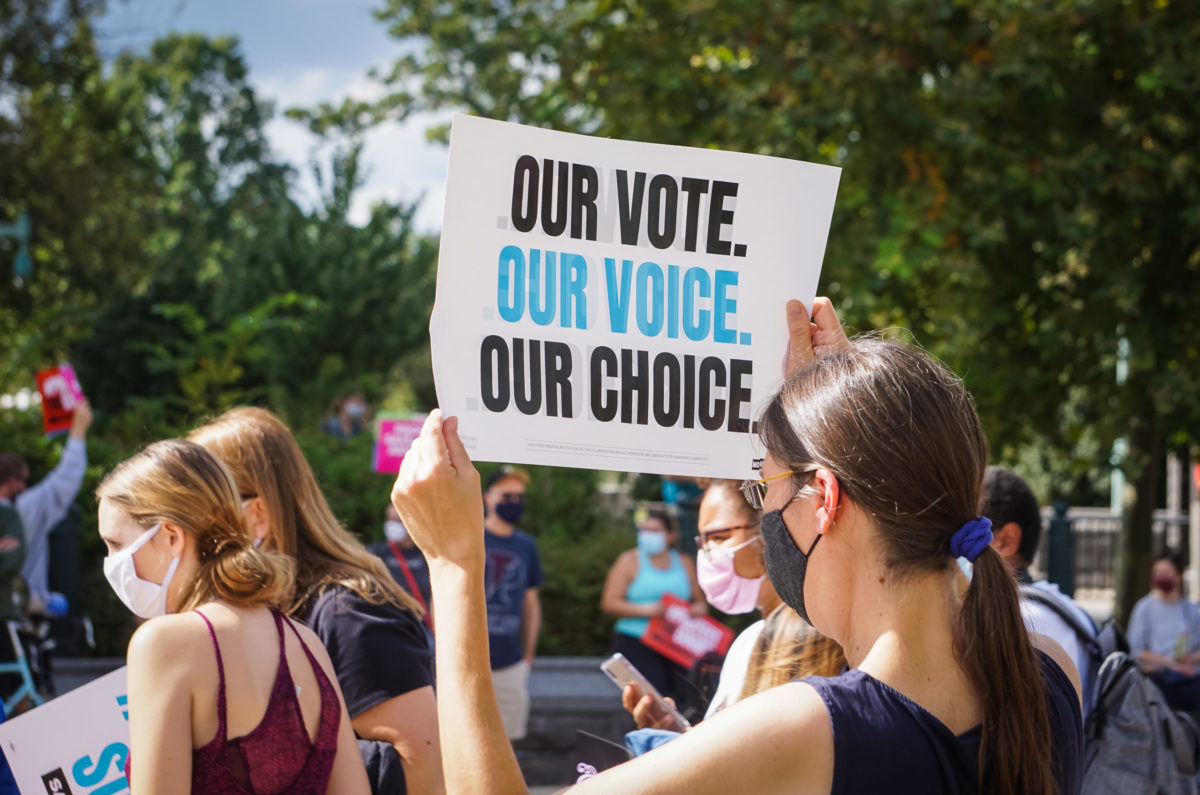 WASHINGTON D.C., USA - SEPTEMBER 27, 2020: A Protestor carries a sign that says "Our Vote, Our Voice, Our Choice," at a protest against the nomination of Amy Coney Barrett to the Supreme Court.