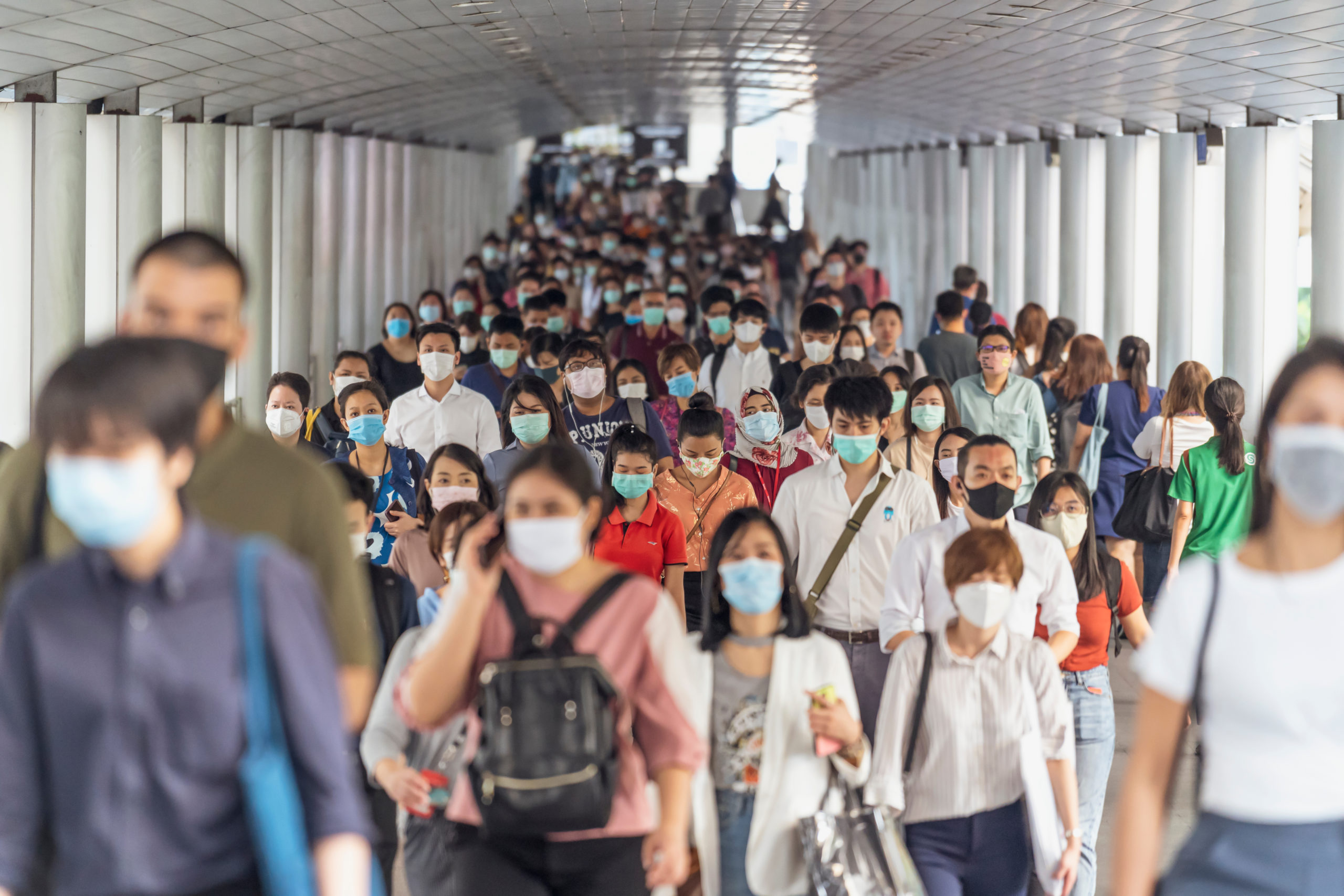 Bill of Health - A crowd of people in a concourse, all wearing masks, permanent masking