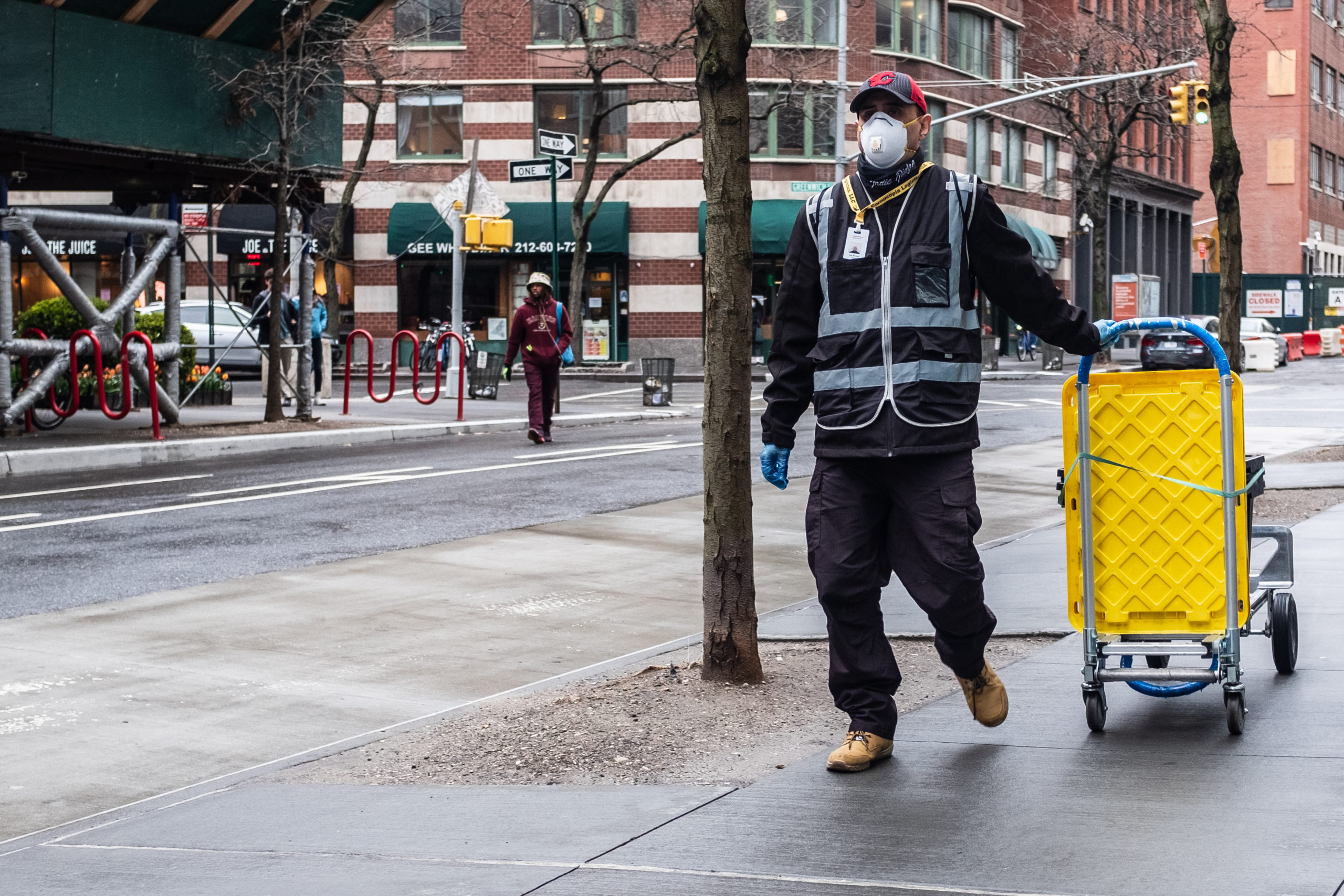 Bill of Health - man walks down street working while wearing masks, workers during the pandemic, protecting workers