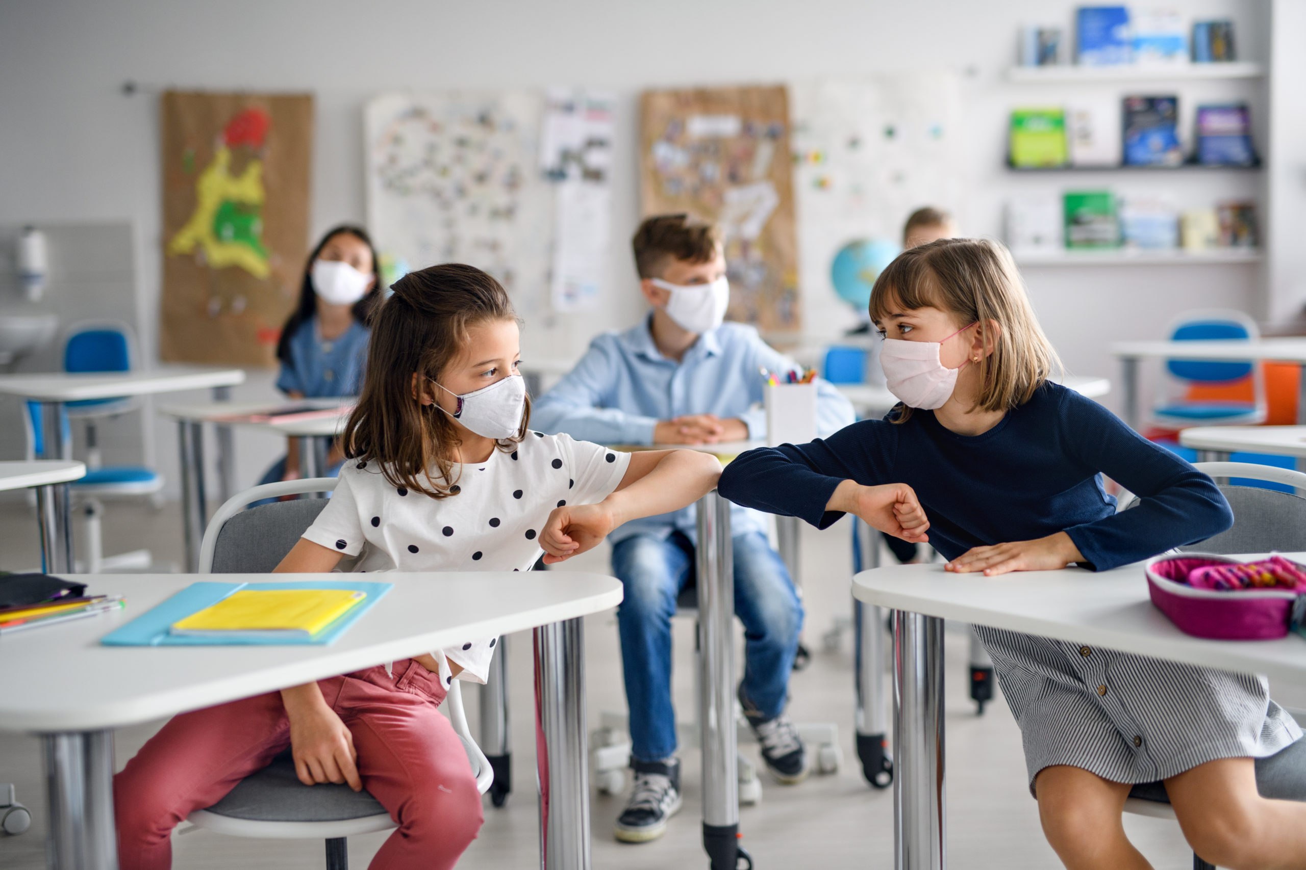 Bill of Health - two girls wearing masks in school bump firsts during covid-19 pandemic