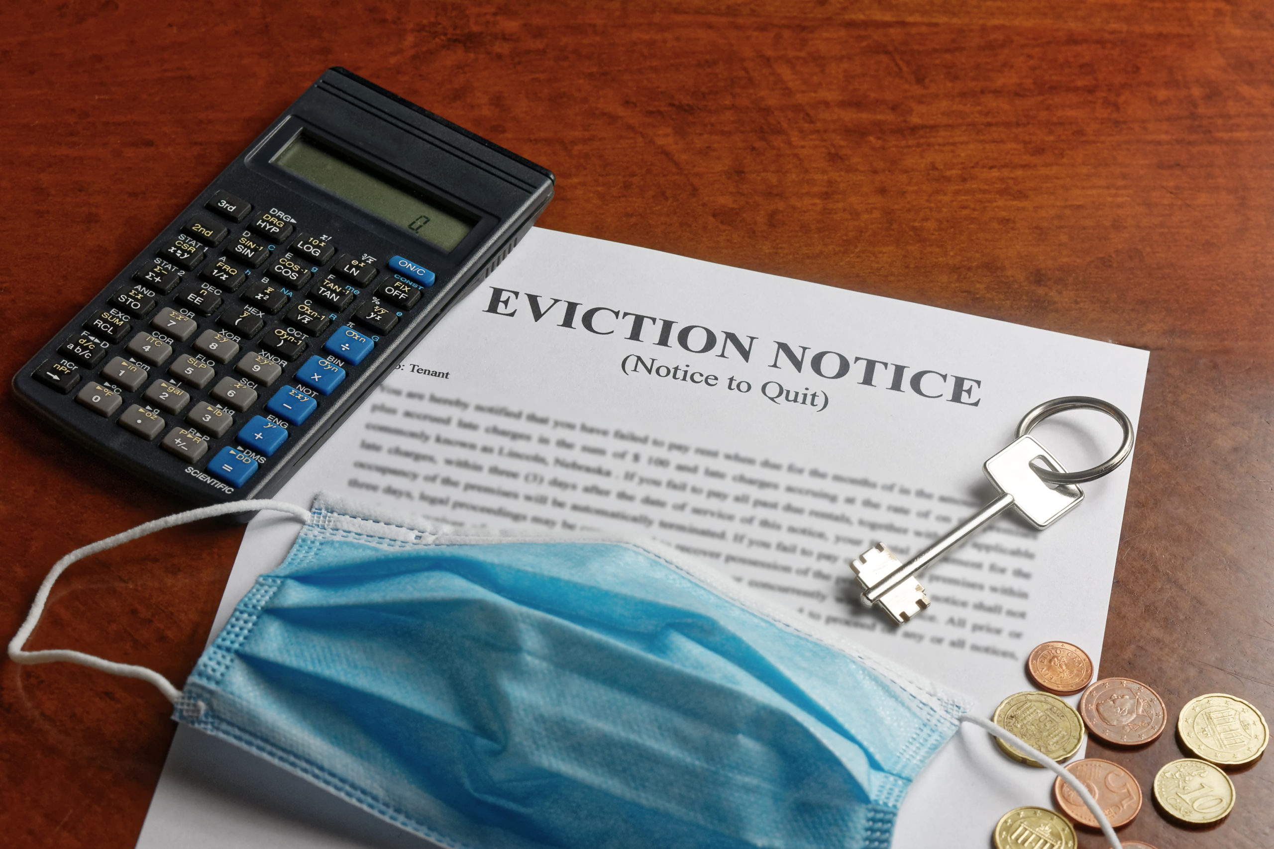 Bill of Health - Mask, calculator, and coins on eviction notice, covid housing evictions