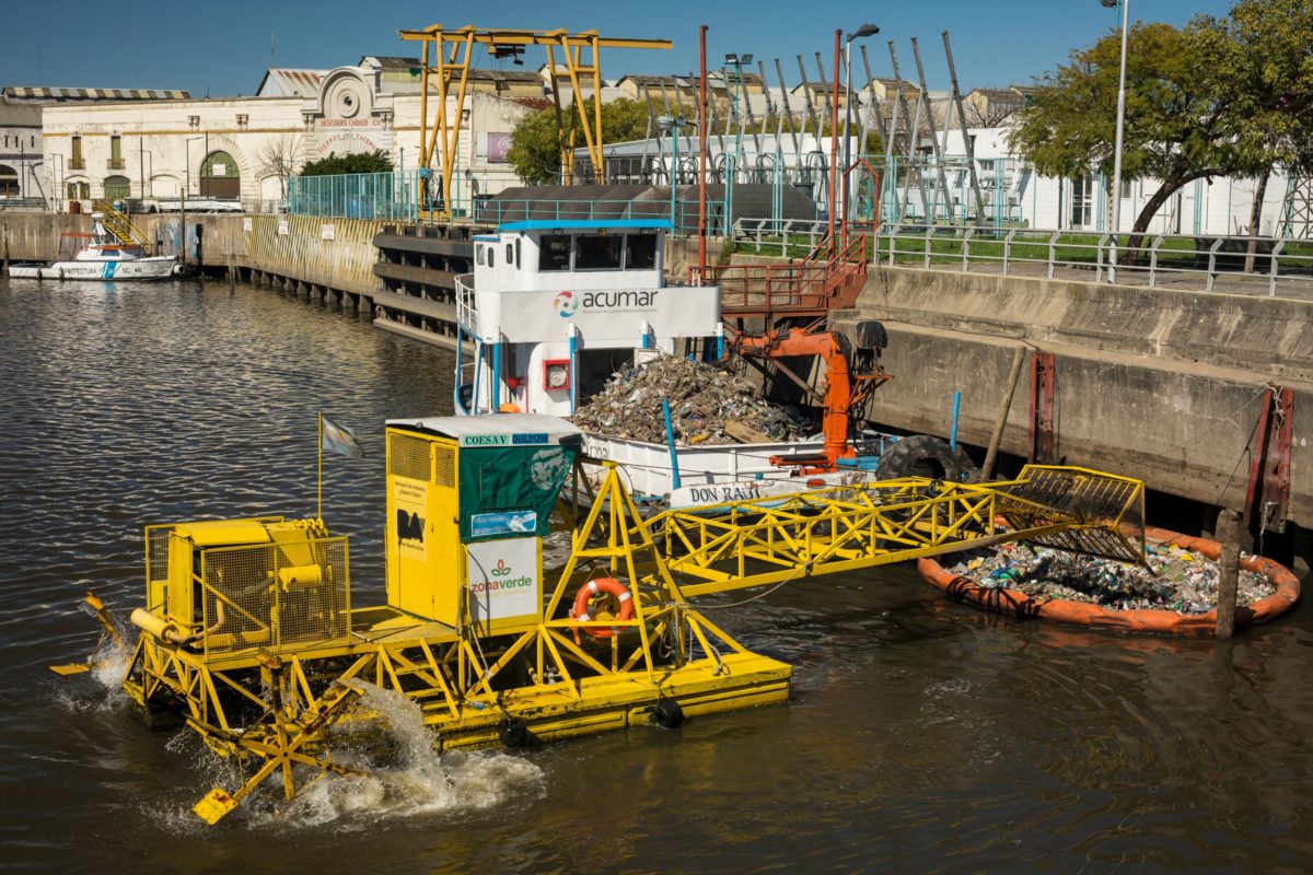 Buenos Aires, Argentina – August 31, 2017: Horizontal view of some waste collector machines over Matanza River (also known as Riachuelo at its mouth in River Plate), La Boca neighborhood.