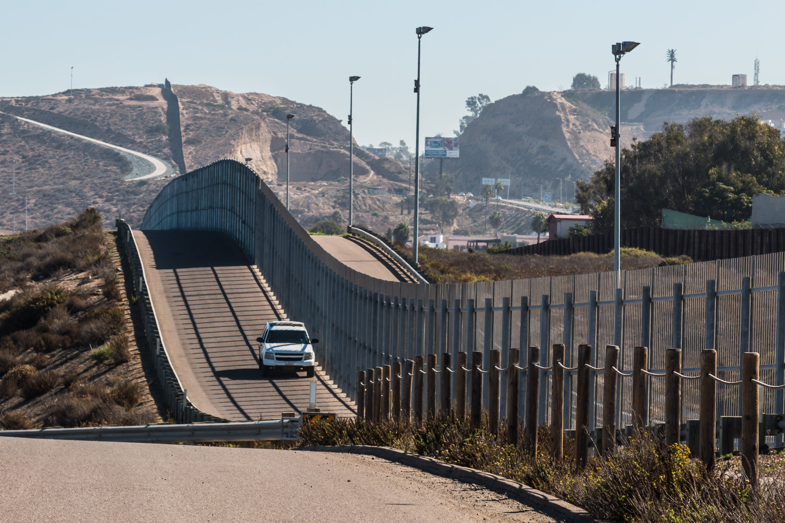 Bill of Health - California USA, truck patrolls road next to fence seperating USA from Mexico, mexico immigration, restrictions on mexican immigration