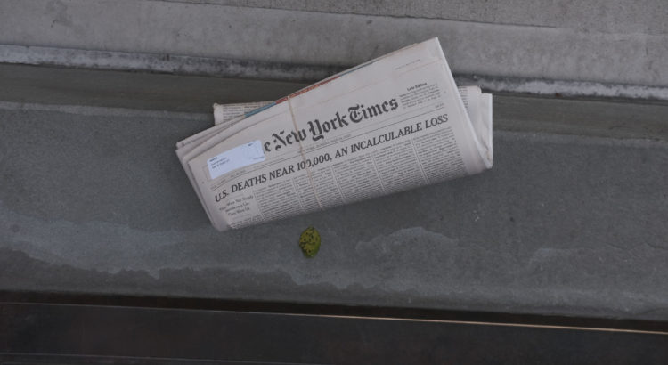 NEW YORK, NY - MAY 24, 2020: New York Times newspaper with "U.S. Deaths Near 100,000, An Incalculable Loss" front-page article delivered to front door in Manhattan.