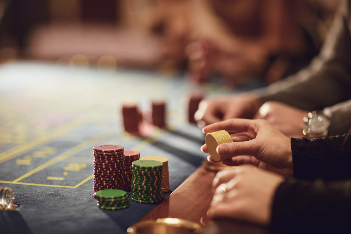 Gamblers make bets at the roulette table in a casino.