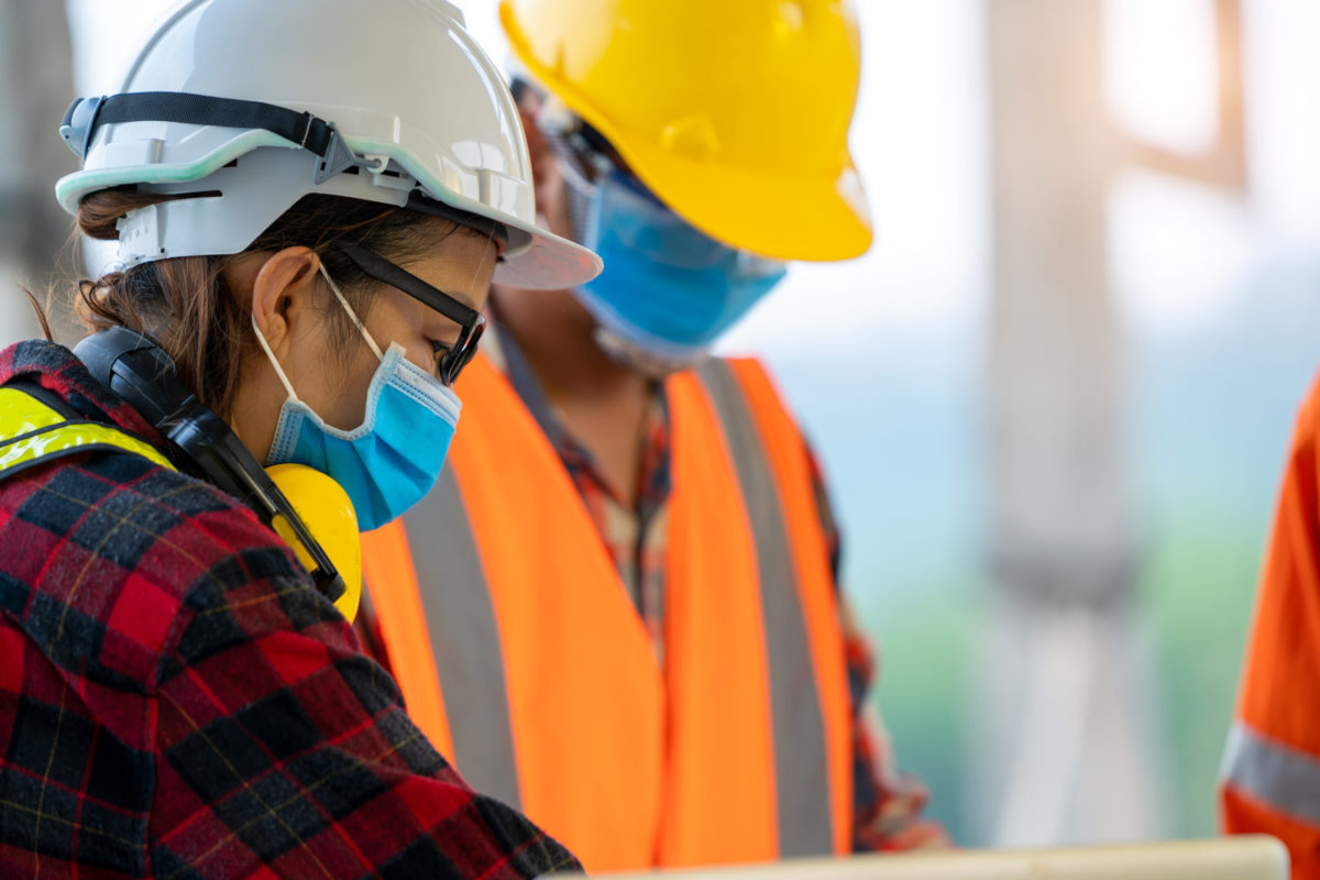 Construction workers wear protective face masks to prevent the spread of Covid-19.