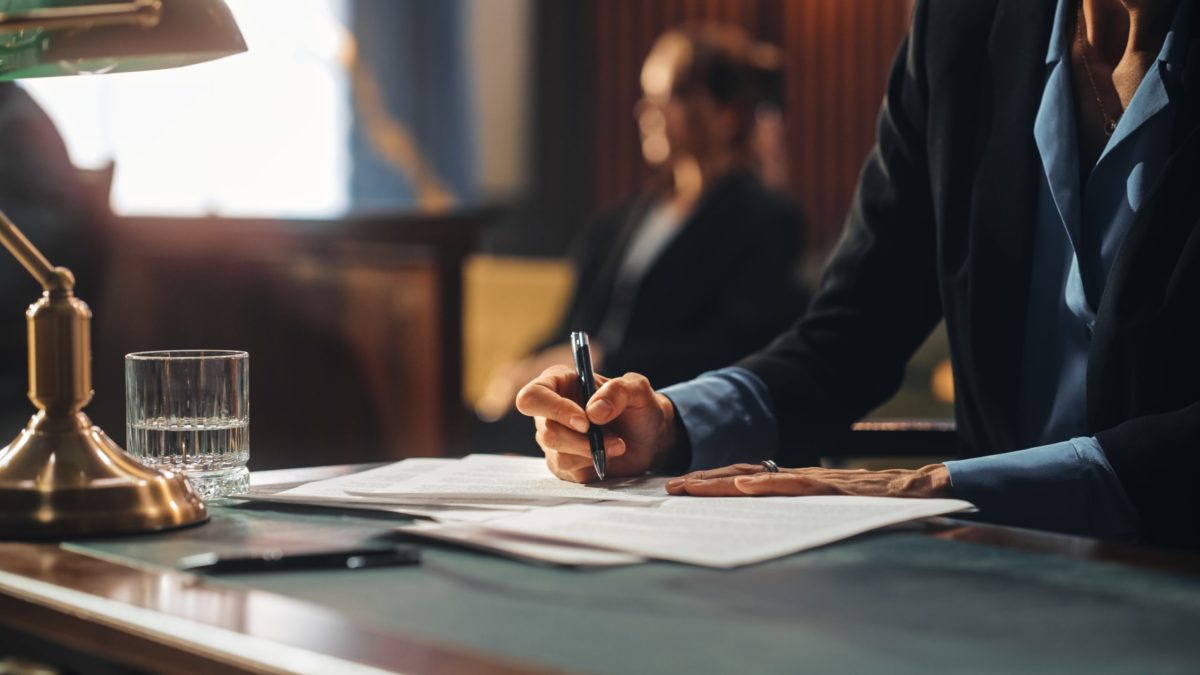 Lawyer and client in courtroom.