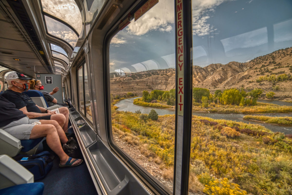 Denver, Colorado, USA 9-21-20 Amtrak Train crossing through the Colorado Rocky Mountains with peak Fall Colors in September.