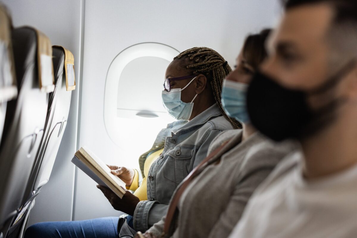 Passengers on a plane wearing masks.