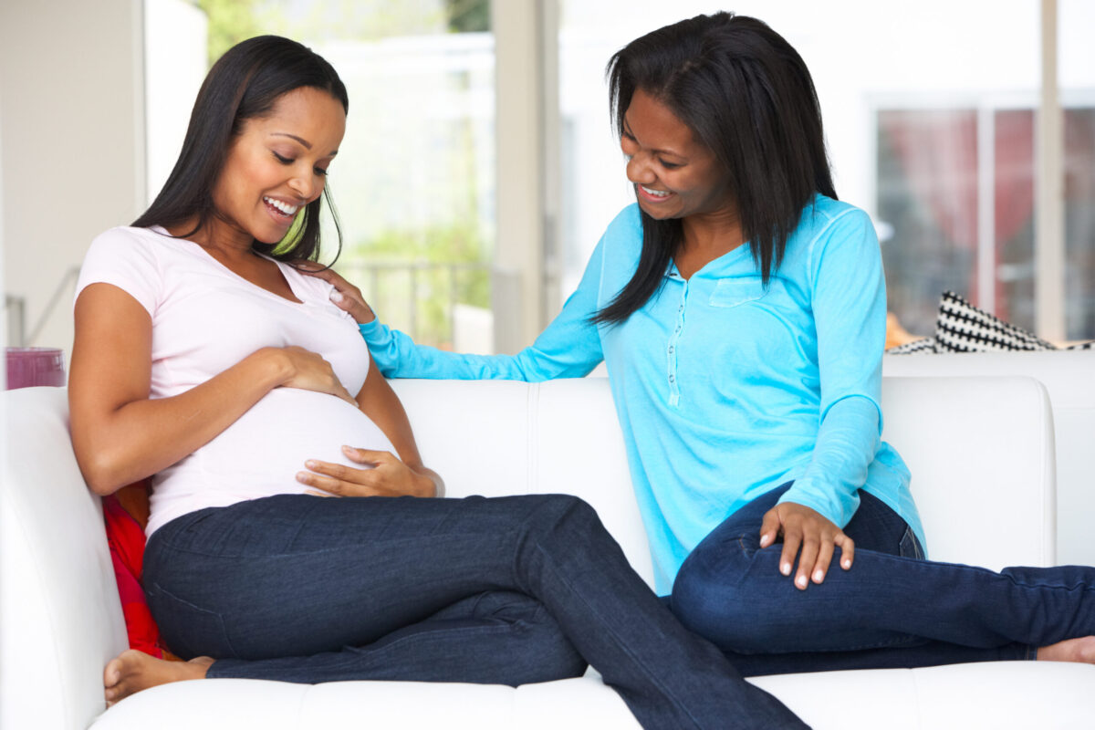 Midwife visiting pregnant woman.