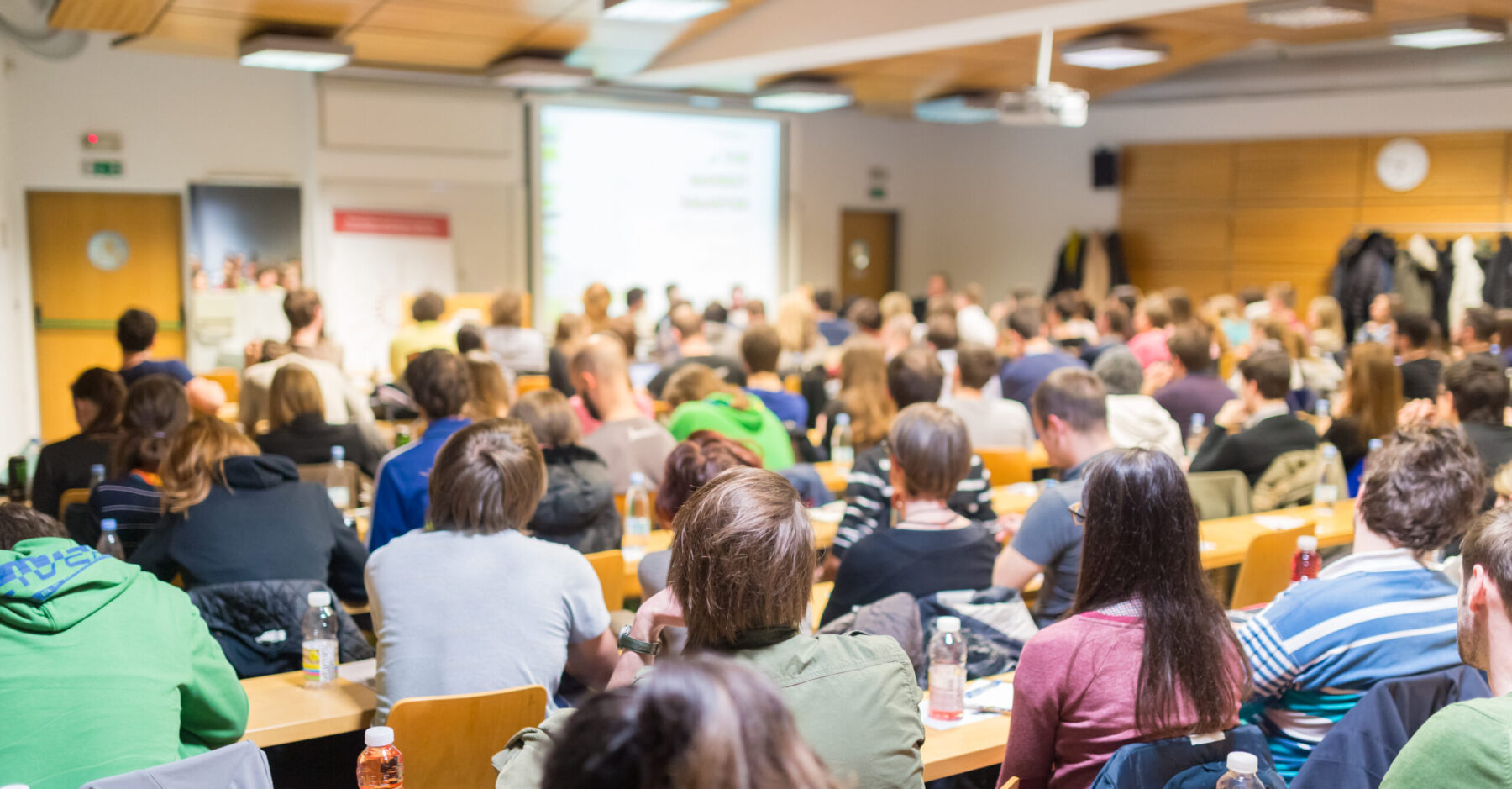 Participants listening to lecture in lecture hall.