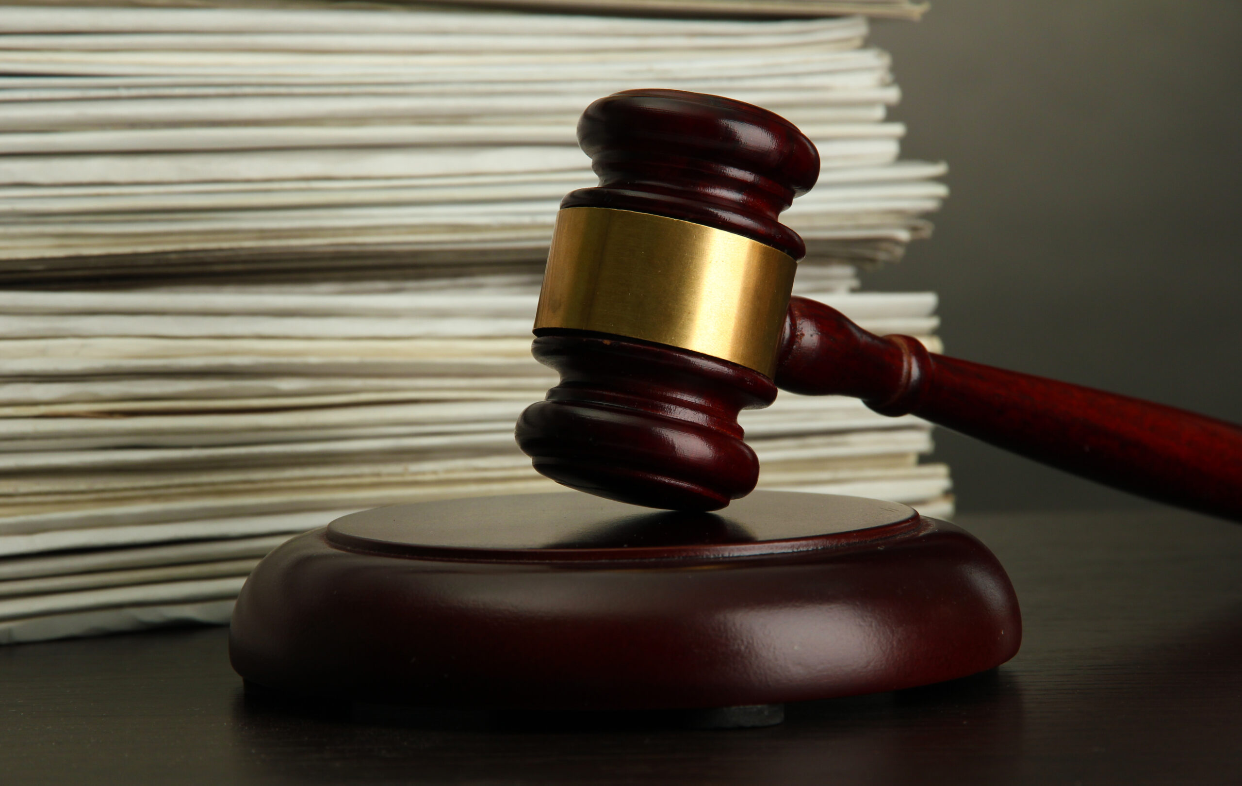 gavel and old papers on grey background.