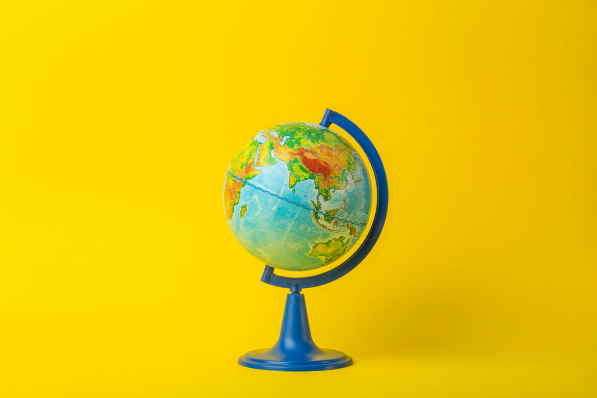 Globe on clean yellow background.