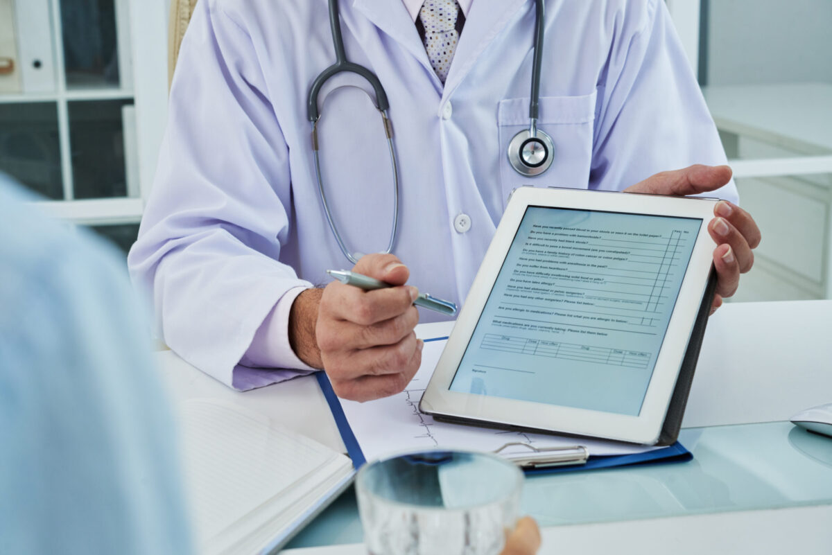 Doctor asking patient to fill out survey before medical treatment.